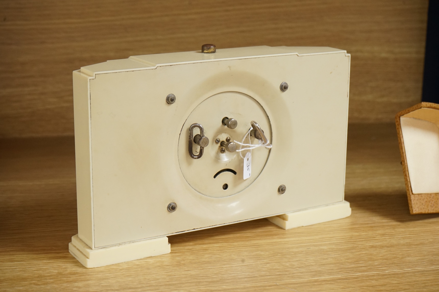 Two Art Deco timepieces comprising a Japy alarm clock and a Jas cased travelling example, largest 22cm wide